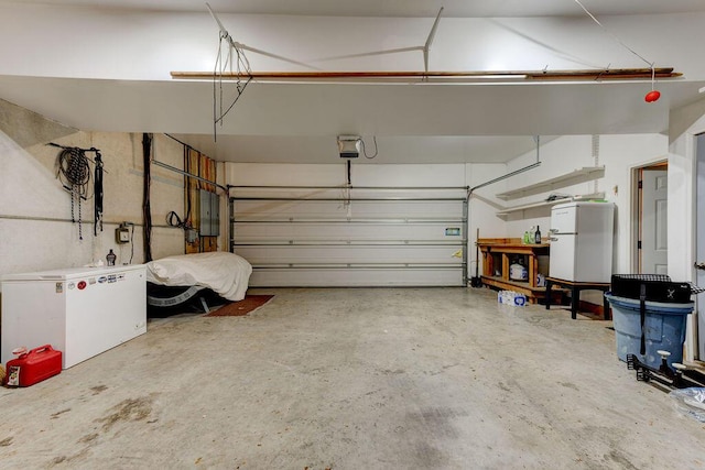 garage with a garage door opener, freestanding refrigerator, fridge, and electric panel