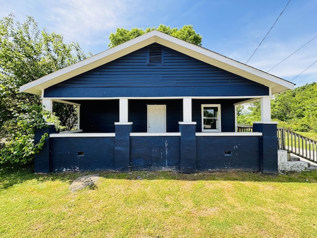 view of property exterior with a lawn and a porch