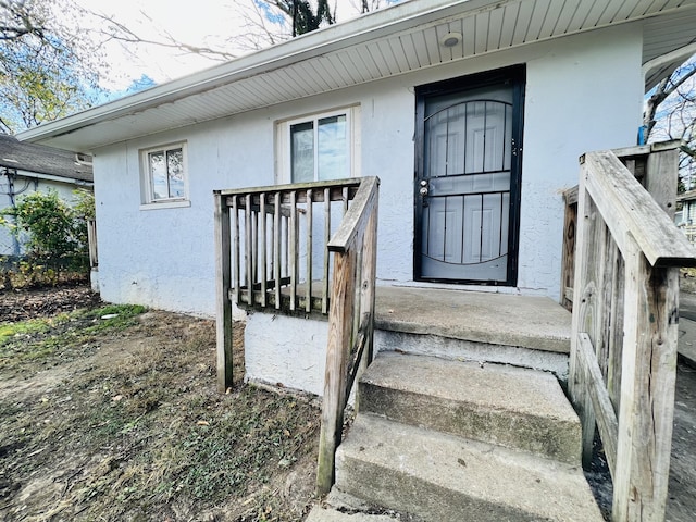 doorway to property with stucco siding