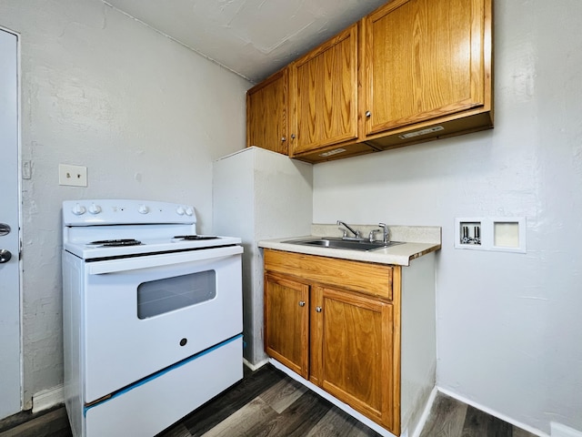 kitchen with white electric range oven, light countertops, brown cabinets, a sink, and dark wood finished floors