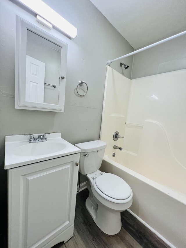 full bathroom with vanity, shower / tub combination, wood finished floors, and toilet