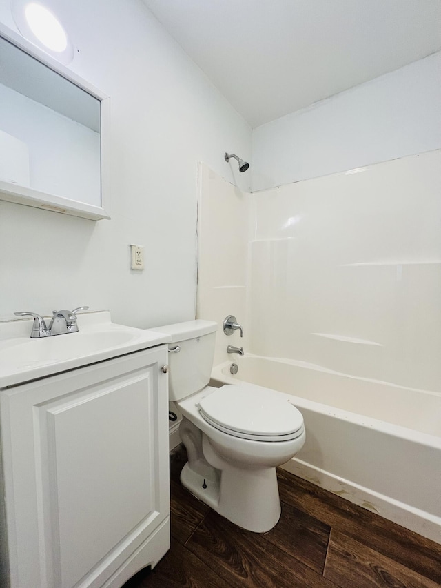 bathroom with vanity, toilet, bathing tub / shower combination, and wood finished floors