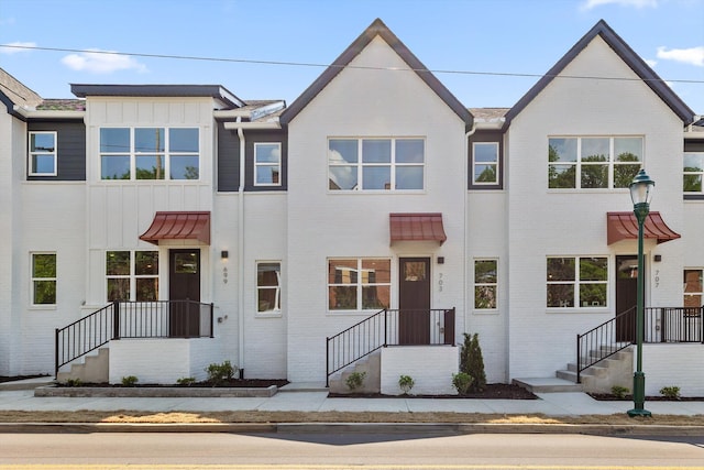 townhome / multi-family property with brick siding and board and batten siding