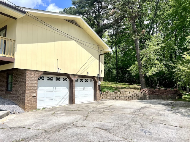 view of property exterior with driveway and brick siding