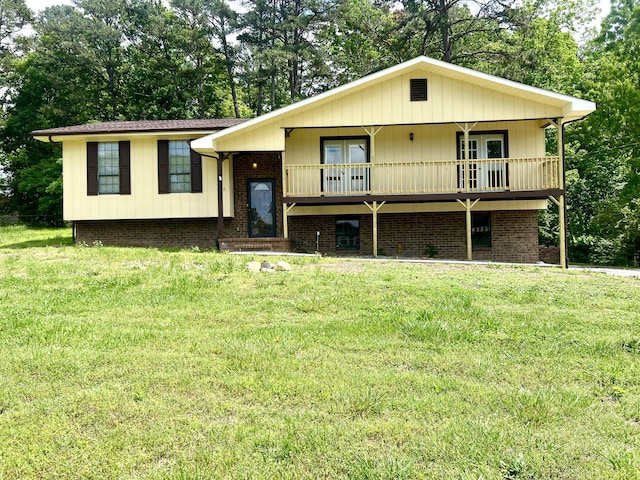 split foyer home featuring french doors and a front lawn