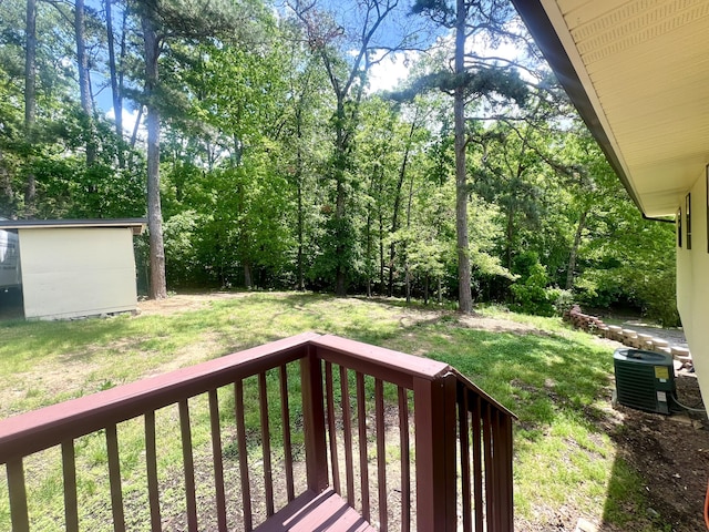 view of yard with a deck and central air condition unit