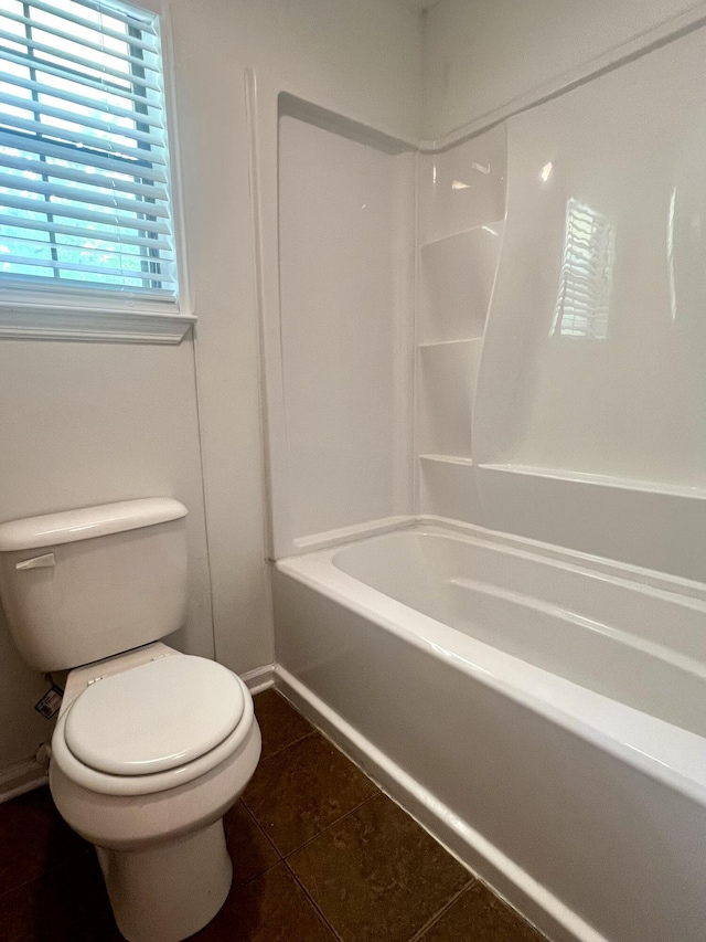 full bathroom with toilet, shower / bathing tub combination, tile patterned floors, and baseboards