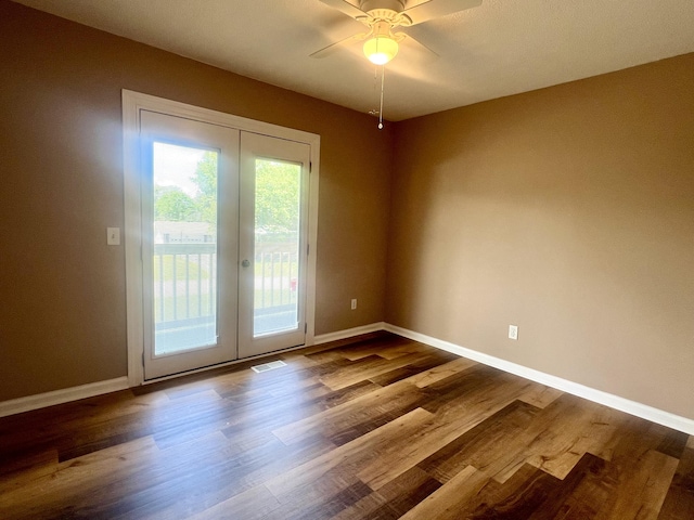spare room with visible vents, dark wood-style flooring, french doors, and baseboards