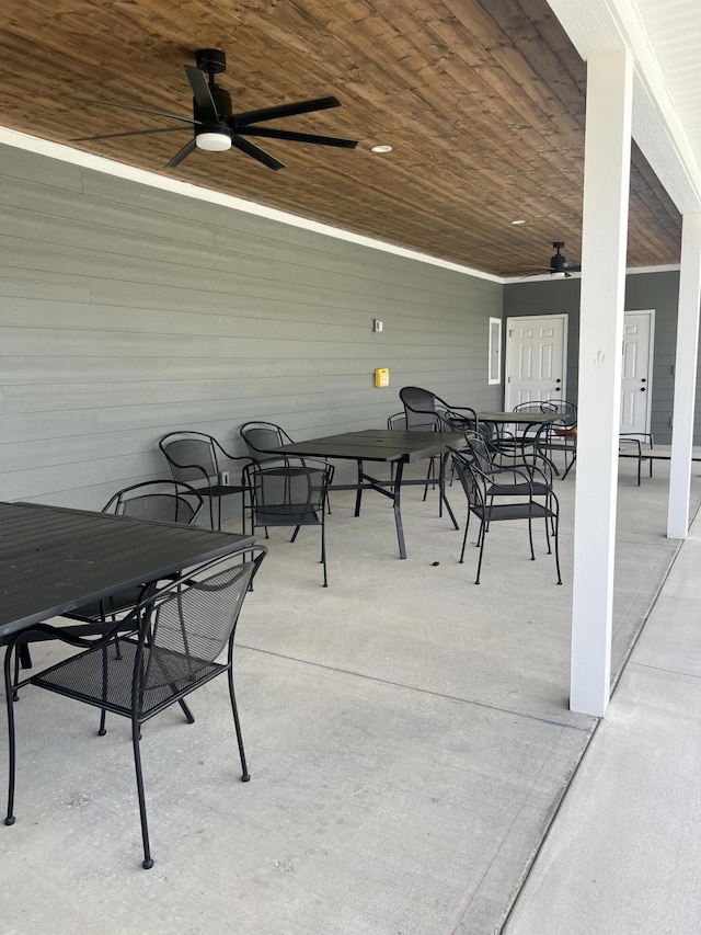 view of patio with outdoor dining space and a ceiling fan