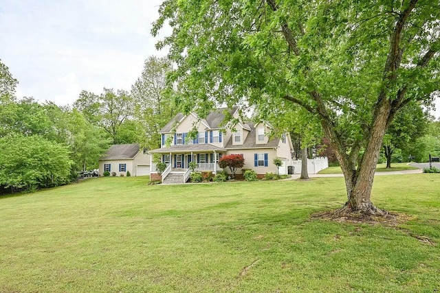 view of front of home featuring a porch, a front yard, and a garage