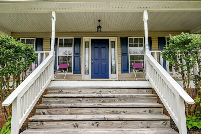 view of exterior entry with a porch