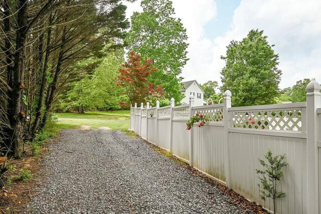 view of street featuring gravel driveway