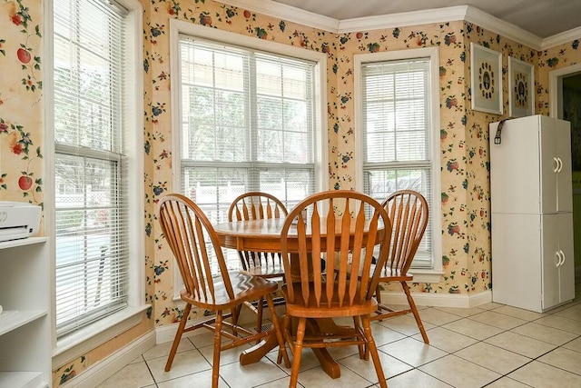 dining space featuring light tile patterned floors, wallpapered walls, ornamental molding, and baseboards