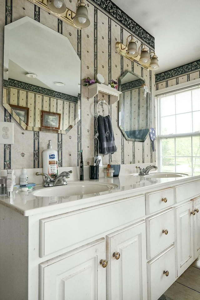 bathroom with vanity and wallpapered walls