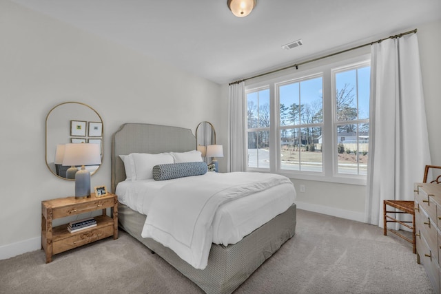 bedroom featuring baseboards, visible vents, and carpet