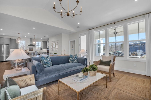 living area featuring wood finished floors, a chandelier, recessed lighting, and vaulted ceiling