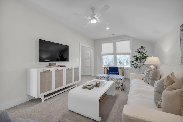 living area with ceiling fan, baseboards, vaulted ceiling, and light carpet