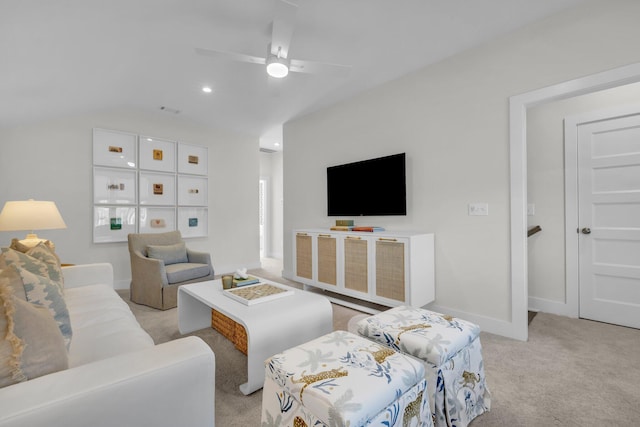 living area featuring a ceiling fan, baseboards, vaulted ceiling, and light carpet