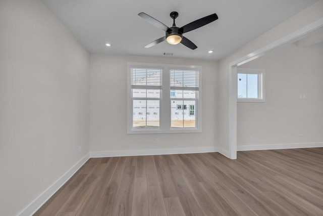 unfurnished room with recessed lighting, a ceiling fan, visible vents, baseboards, and wood finished floors