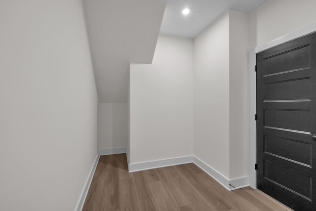 interior space with baseboards, recessed lighting, and wood finished floors