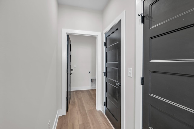 hallway with baseboards and light wood-type flooring