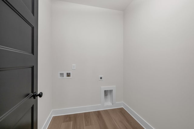 washroom with hookup for an electric dryer, baseboards, hookup for a washing machine, wood finished floors, and laundry area