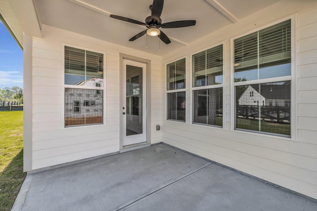 doorway to property with ceiling fan and a patio area