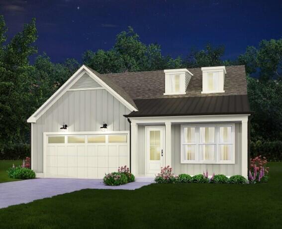 modern farmhouse featuring board and batten siding, concrete driveway, a standing seam roof, an attached garage, and a front lawn
