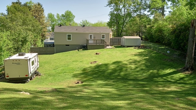back of property featuring an outdoor structure, a lawn, a shed, and a fenced backyard