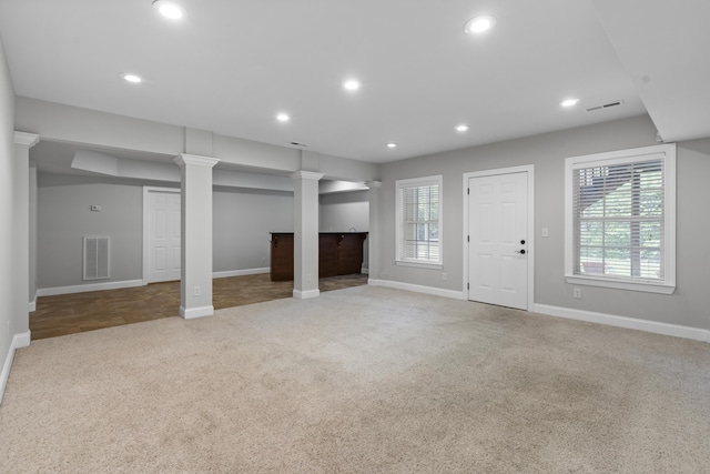 unfurnished living room with visible vents, carpet flooring, and a healthy amount of sunlight