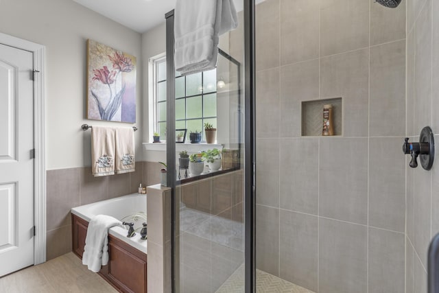 bathroom with a garden tub and a shower stall
