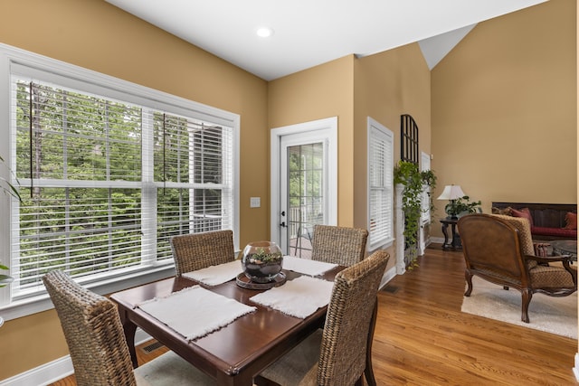 dining space featuring recessed lighting, baseboards, and light wood finished floors