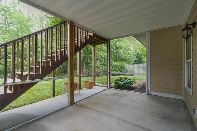 view of patio with fence and stairway