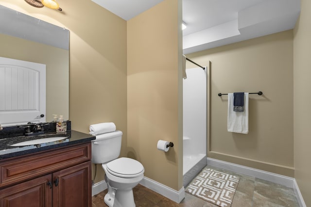 full bath featuring vanity, baseboards, toilet, and a shower