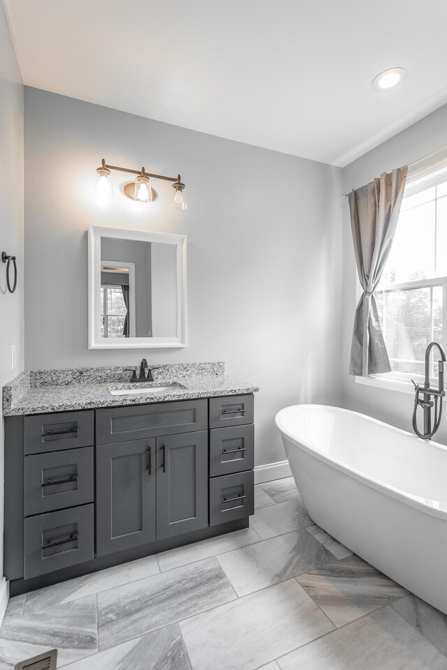 485 Woodland Dr, Jasper, TN 37347 - bathroom with a freestanding bath, vanity, baseboards, marble finish floor, and recessed lighting