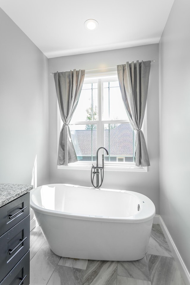 485 Woodland Dr, Jasper, TN 37347 - bathroom featuring baseboards, a freestanding bath, marble finish floor, and vanity