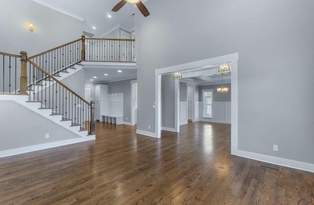 8520 Winter Refuge Way, Ooltewah, TN 37363 - unfurnished living room featuring stairway, baseboards, wood finished floors, high vaulted ceiling, and ceiling fan with notable chandelier