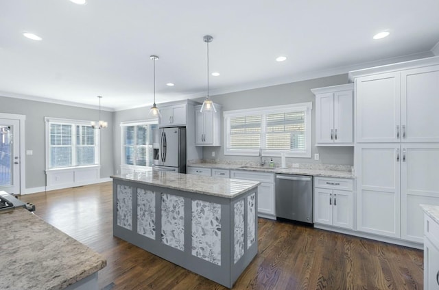 8520 Winter Refuge Way, Ooltewah, TN 37363 - kitchen featuring white cabinets, a sink, stainless steel appliances, a center island, and ornamental molding