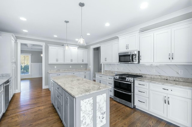 8520 Winter Refuge Way, Ooltewah, TN 37363 - kitchen with stainless steel appliances, tasteful backsplash, a center island, ornamental molding, and white cabinets