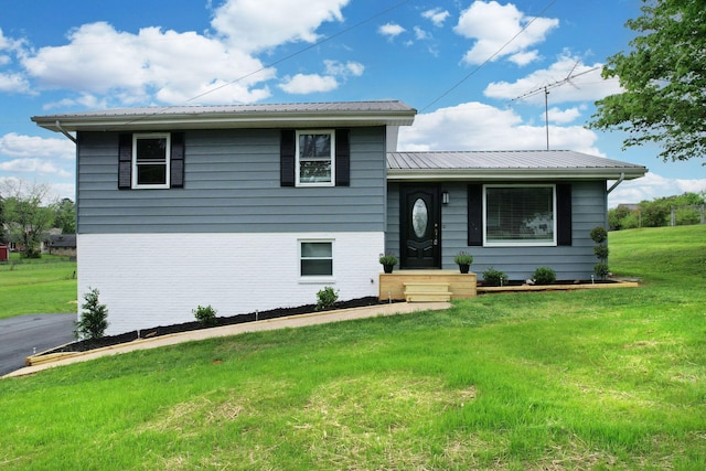1680 Rolling Brook Dr NE, Cleveland, TN 37323 - split level home with a front lawn, metal roof, and brick siding