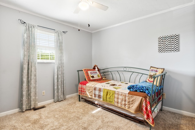carpeted bedroom with a ceiling fan, baseboards, visible vents, and ornamental molding