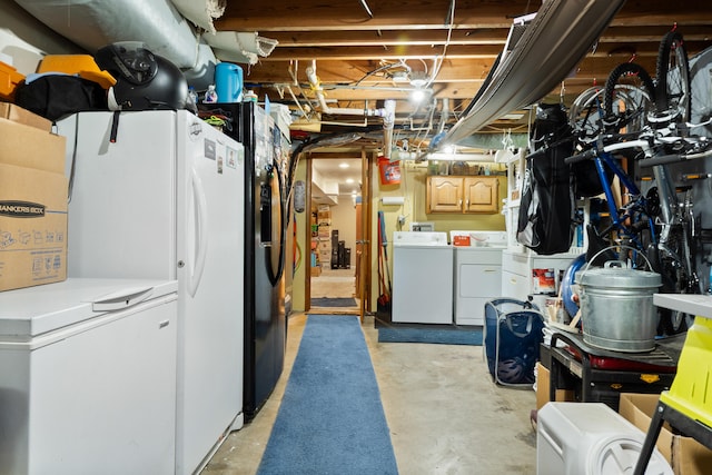 unfinished basement with refrigerator and washing machine and dryer