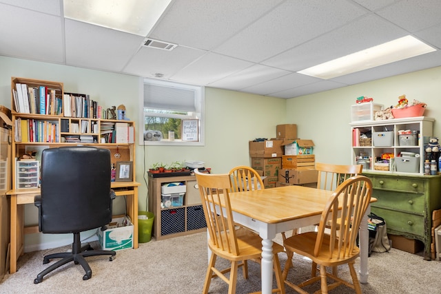 carpeted dining room with visible vents and a drop ceiling