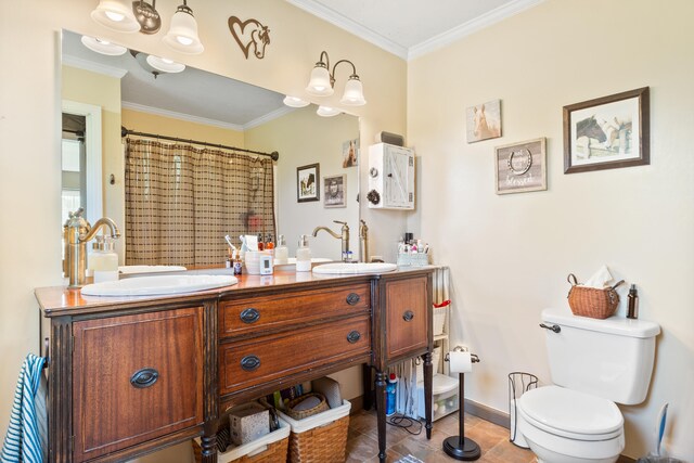 full bathroom with a sink, baseboards, crown molding, and toilet