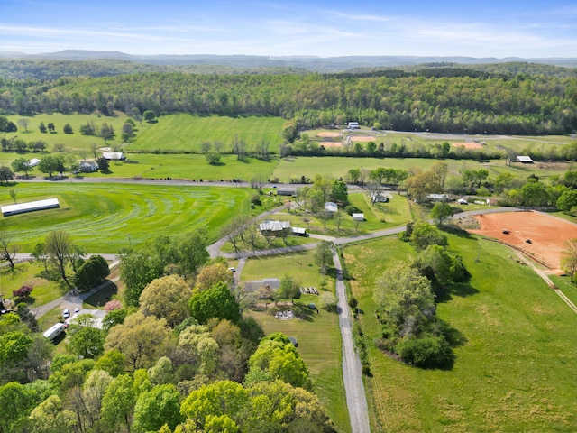 drone / aerial view featuring a rural view and a wooded view