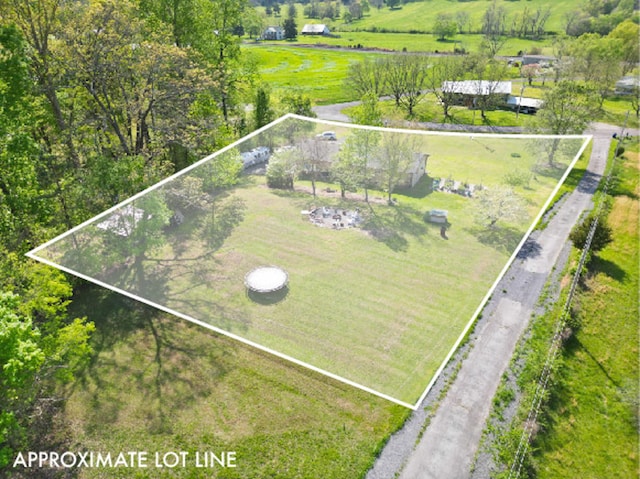 birds eye view of property with a rural view