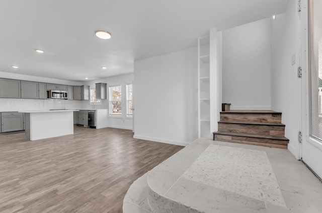 interior space with recessed lighting, baseboards, stairway, and light wood-type flooring