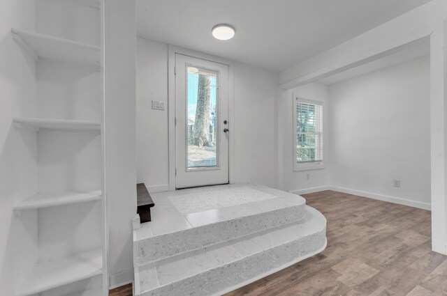 unfurnished bedroom with baseboards and wood finished floors
