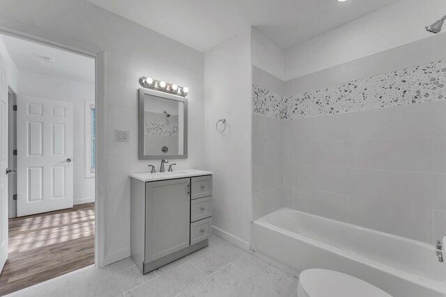 full bathroom featuring baseboards, vanity, toilet, and shower / tub combination