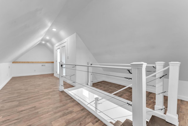 additional living space with recessed lighting, baseboards, vaulted ceiling, and wood finished floors